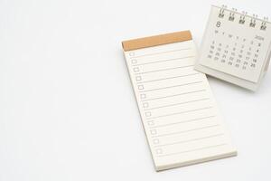 Blank Check list or Empty small notepad for text with checkbox and Simple desk calendar for AUGUST 2024. Blank to do list for text in AUG. Copy Space. photo