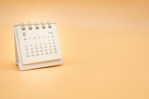 Simple desk calendar for JUNE 2024 isolated on orange background. Calendar concept with copy space. photo