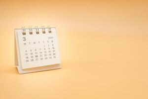 Simple desk calendar for MARCH 2024 isolated on orange background. Calendar concept with copy space. photo