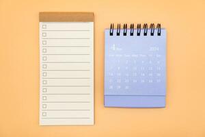 Blank to do list for text with checkbox and Simple desk calendar on APRIL 2024. Empty Check list. Copy Space. isolated background. To do list in April 2024. photo