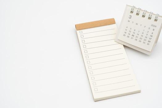 Blank Check list or Empty small notepad with checkbox and Simple desk calendar for MARCH 2024. Blank checklist for text. Copy Space. photo