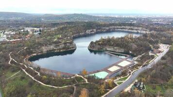 Aerial View of Zakrzowek Lake in Autumn, Scenic aerial view of Zakrzowek Lake surrounded by autumn foliage and limestone cliffs in Krakow, Poland. video