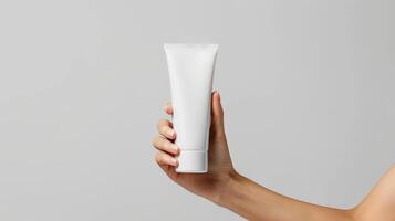 AI generated female hand holding a white cosmetic product, mockup tube of cream on a white isolated background photo