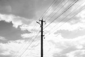 Power electric pole with line wire on dark background close up photo