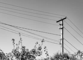 Power electric pole with line wire on light background close up photo