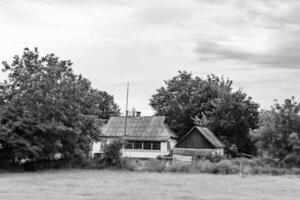 Beautiful old abandoned building farm house in countryside on natural background photo