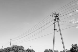 Power electric pole with line wire on light background close up photo