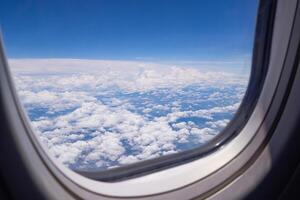 Bright blue sky and white clouds. Beautiful above sky panoramic view from the window of an airplane flying in the clouds. Feeling freedom and new inspiration. Skyline background with copy space photo