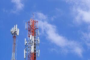 Telecommunication tower with bright blue sky and clouds background. Satellite dish telecom network for communication technology. Space for text photo