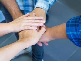 Top view of hands joined together. Concept of unity and teamwork photo