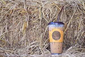 Iced coffee cup placed on straw in the cafe shop. Space for text. Concept of beverages photo