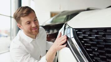 A man examine vehicle before making purchase. Buy car video