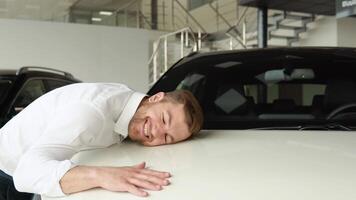 A happy man hug his new car, smiling gently video