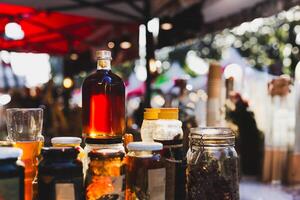 Honey in bottles with display for sale in store. photo