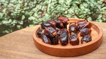 closeup sweet dried date palm fruits or kurma, ramadan food photo