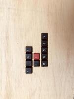 Black and red keys on a wooden background with space for text. photo