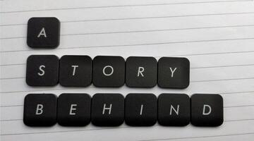 word a story on black button on lined paper background, business and education concept photo