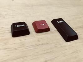 Keyboard keys on a wooden background. Selective focus. Toned. photo