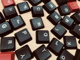 keyboard keys on wood background - vintage effect style picture, selective focus photo