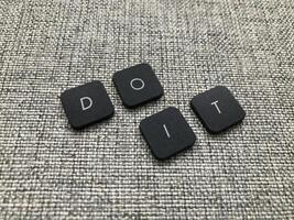 Do it text on grey carpet. Motivational and inspirational background. photo