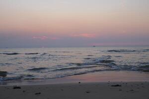 Sunset on the beach of the Sea photo