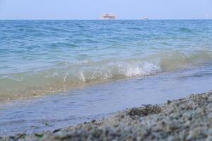 Sea waves on the sandy beach in the summer. Background of the sea. photo