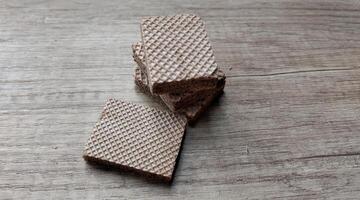 Chocolate wafers on wooden background. Selective focus. photo