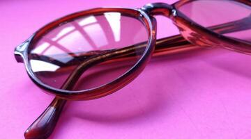 Glasses on a pink background. View from above. Place for text. photo