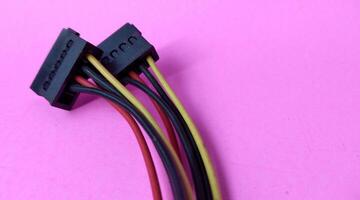 Close up of computer cable isolated on pink background with copy space. photo