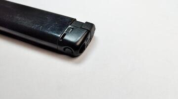 Black lighter on a white background, close-up, isolate. photo