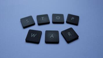 Stop war word made from black plastic buttons on grey background, stop war concept photo