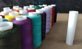 colorful spools of thread for embroidery close up background photo