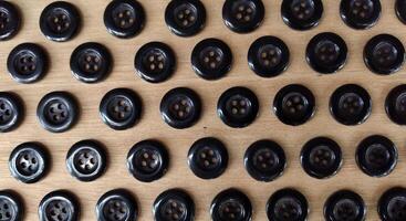 Wooden buttons on a wooden table. Close-up. Selective focus. photo