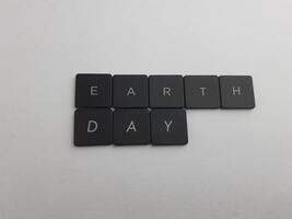 The word earth day spelled out with black buttons on a white background photo