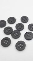 Black sewing buttons isolated on white background. Copy space for text. photo