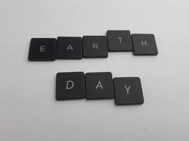 The word earth day spelled out with black buttons on a white background photo