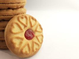 cookies with strawberry jam on a white background, close up photo