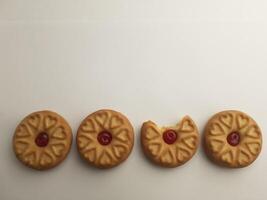 cookies with strawberry jam on a white background, close up photo