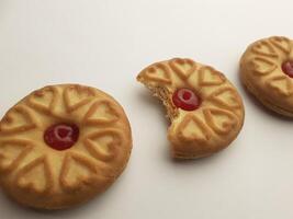 cookies with strawberry jam on a white background, close up photo