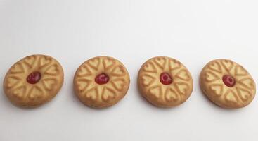 cookies with strawberry jam on a white background, close up photo