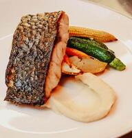 Gourmet salmon loin dish with vegetables photo