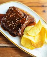 Pork ribs with sweet and sour barbecue sauce photo