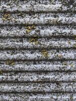 background, texture of ribbed cement fence with flames from rain and lichen, grunge photo