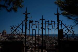 a beautiful wrought iron gate in the foreground of a top view of genoa photo