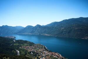 Lake Como with charming yachts surrounded by hills photo