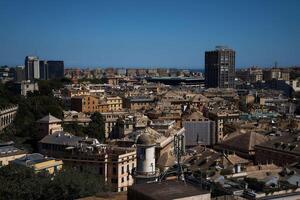 roofs of houses in Genoa with a view of the sea on a sunny day photo