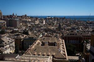 roofs of houses in Genoa with a view of the sea on a sunny day photo