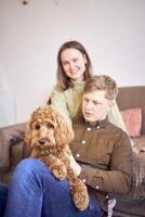 cockapoo in the hands of parents photo