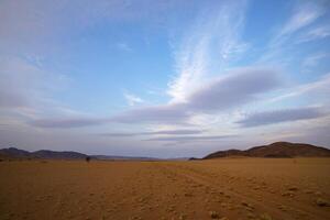 Barren arid desert after sunset photo