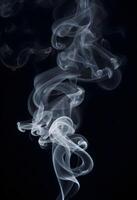 AI generated White smoke fragments on black background photo